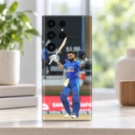 Virat Kohli mobile skin showing a raised bat and helmet celebration in blue India uniform, daylight shelf display