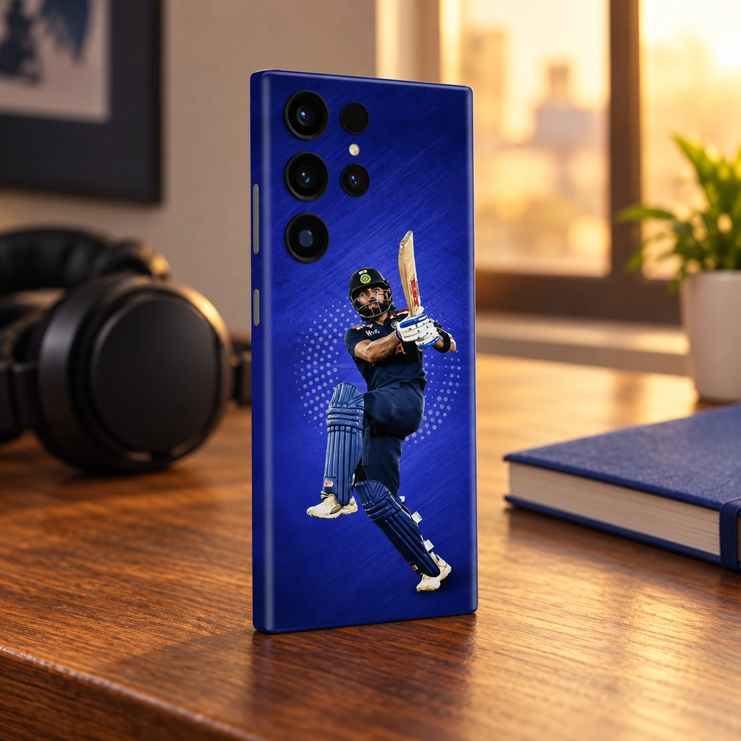 Virat Kohli Batting Blue Mobile Skin – Warm walnut desk Virat Kohli batting photo mobile skin on royal blue, warm walnut desk