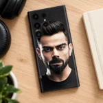 Virat Kohli Black Portrait Mobile Skin shown in a wood flat lay setting
