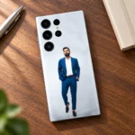 Virat Kohli photo mobile skin on a walnut desk beside a notebook