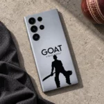 Silver-gray Virat Kohli GOAT mobile skin with black cricketer silhouette, cricket flat lay
