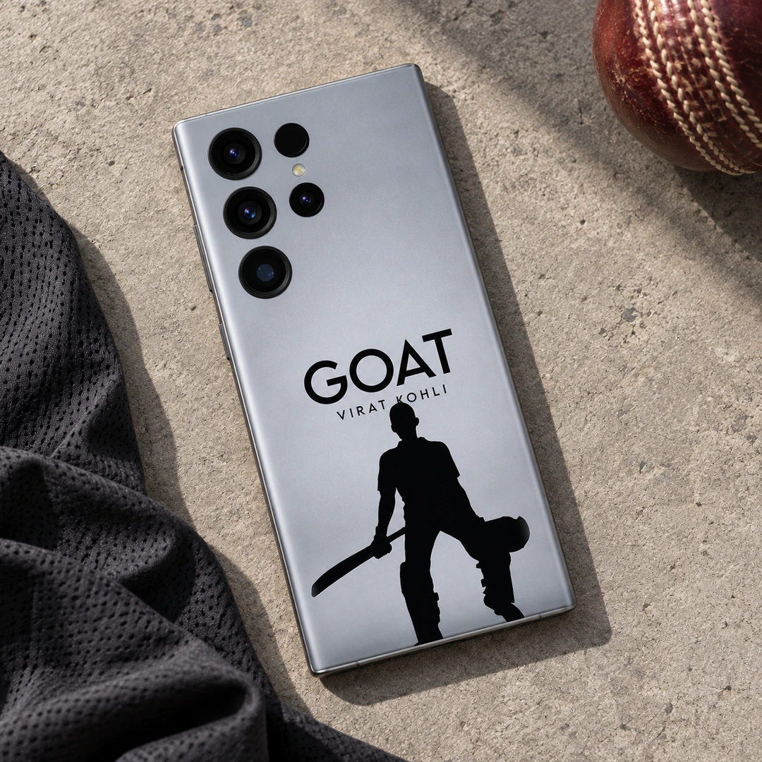 Virat Kohli GOAT Mobile Skin – cricket flat lay Silver-gray Virat Kohli GOAT mobile skin with black cricketer silhouette, cricket flat lay