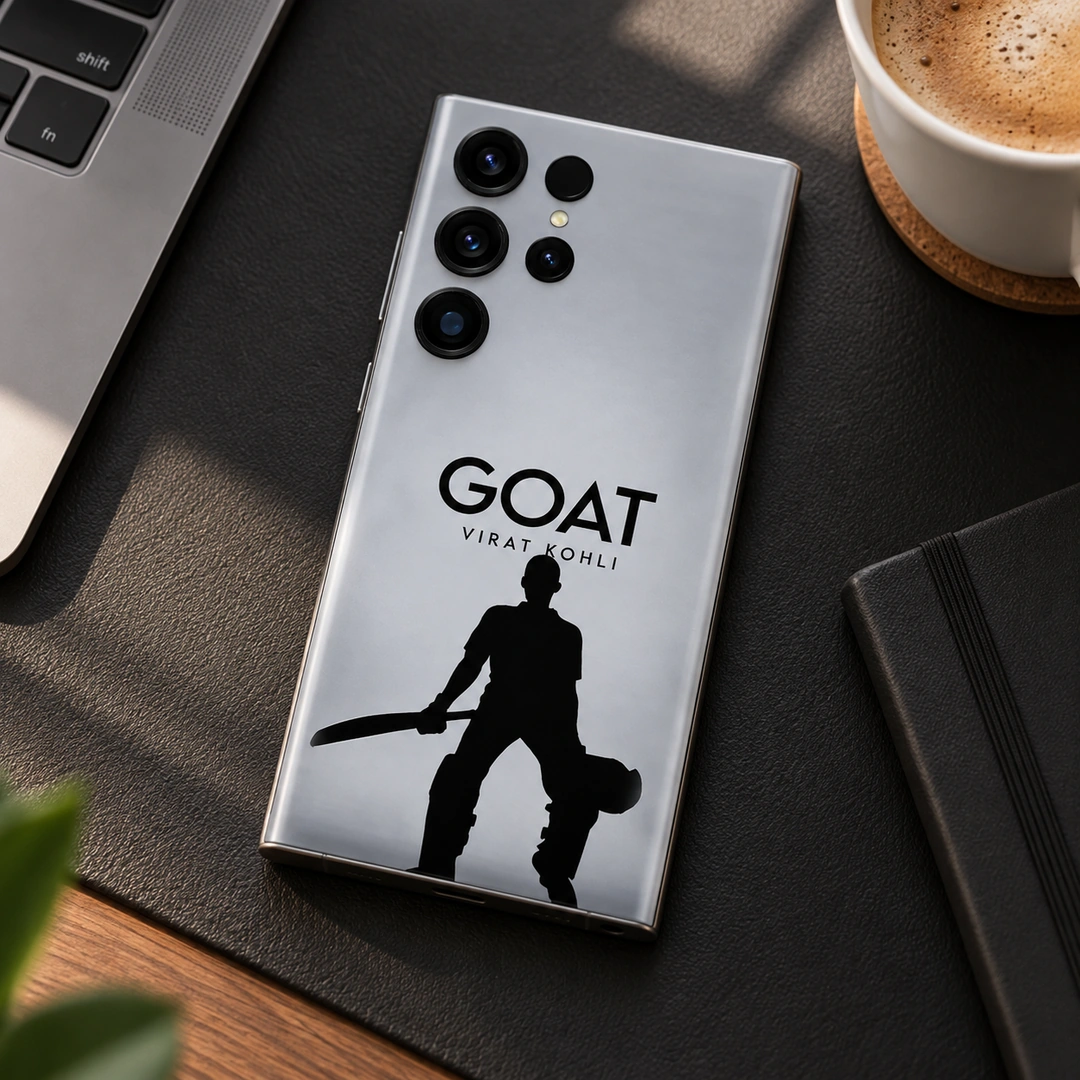 Virat Kohli GOAT Mobile Skin – minimal desk view Silver-gray Virat Kohli GOAT mobile skin with black cricketer silhouette, minimal desk view