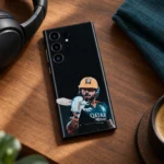 Virat Kohli mobile skin with gold helmet and bat portrait on black, cafe tabletop
