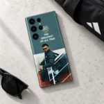Virat Kohli photo phone skin with THE GREATEST OF ALL TIME quote, concrete desk flat lay