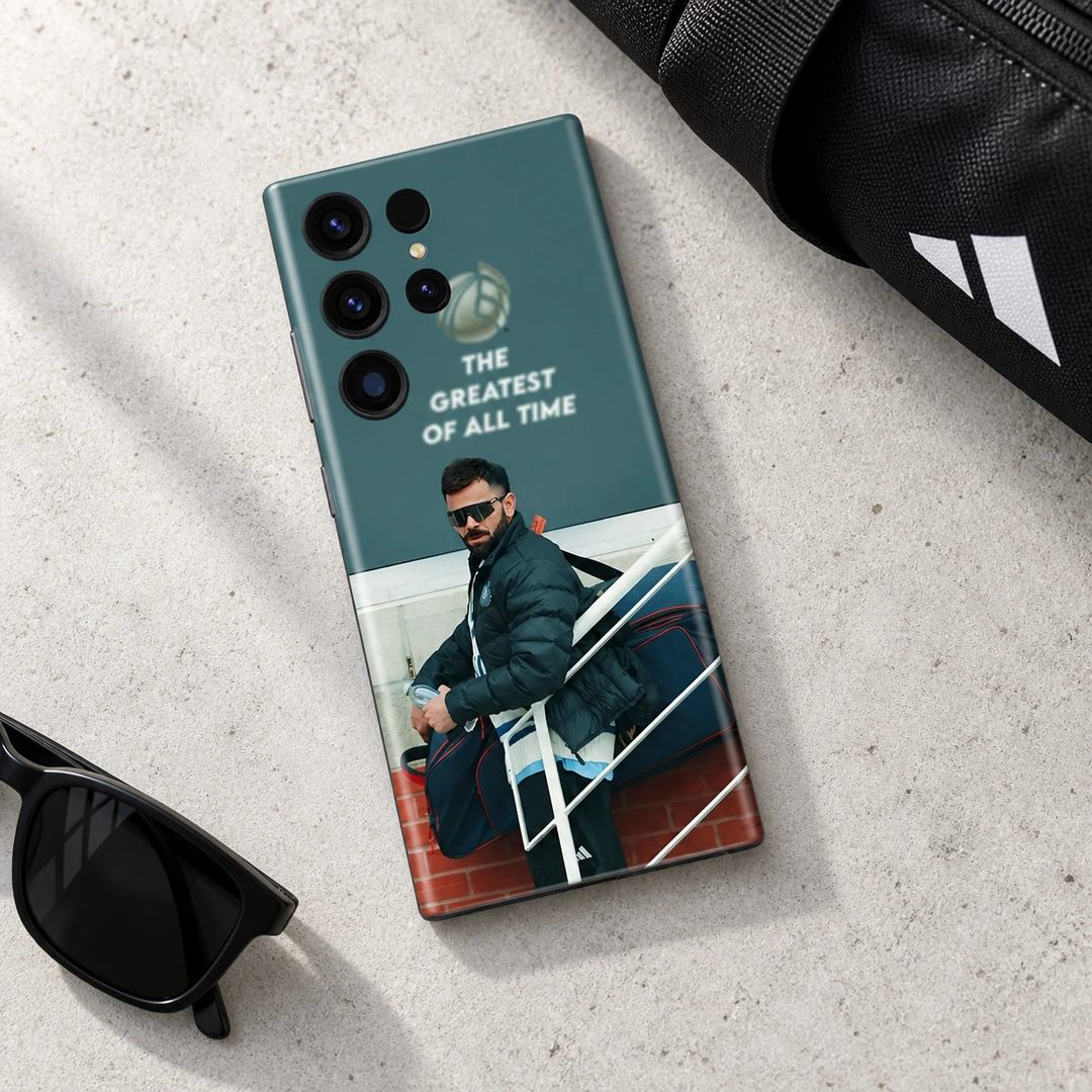 Virat Kohli Photo Mobile Skin - Concrete desk flat lay Virat Kohli photo phone skin with THE GREATEST OF ALL TIME quote, concrete desk flat lay