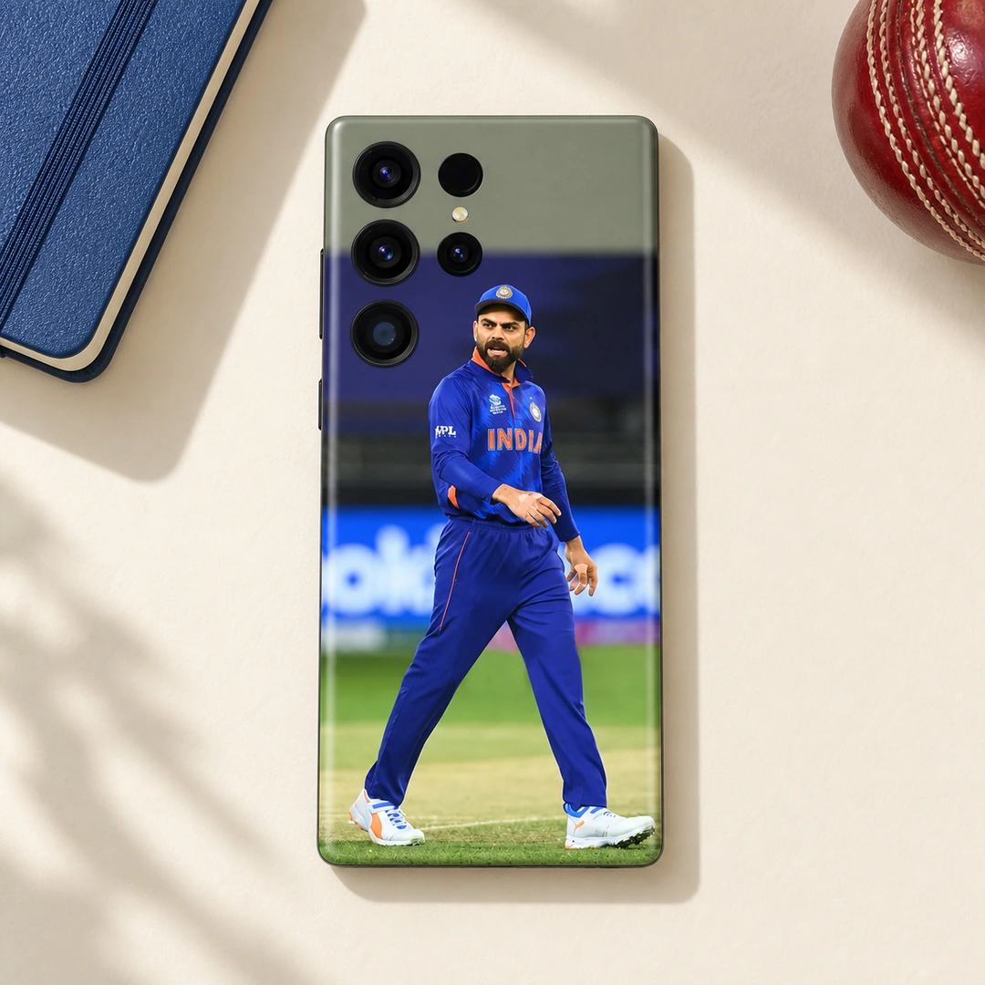 Virat Kohli India On-Field Mobile Skin – daylight flat lay Virat Kohli mobile skin with full-length blue India uniform photograph in daylight flat lay view