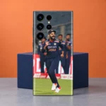 Virat Kohli navy India kit celebration mobile skin in orange studio setting