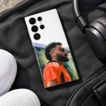 Virat Kohli photo mobile skin with orange shirt portrait and white upper design, sports bag flat lay