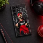 Virat Kohli red and black Play Bold mobile skin, dark desk flat lay