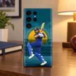 Virat Kohli mobile skin with blue batting pose and teal stadium design, warm walnut desk