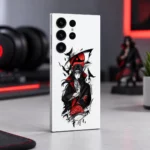 White Itachi Uchiha mobile skin with red eye and black crow artwork, minimal gaming desk angle