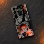 Sukuna mobile skin with gray manga collage and orange Japanese lettering, slate flat lay