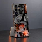 Sukuna mobile skin with gray manga collage and orange Japanese lettering, steel stand angle