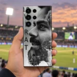 Hand holding monochrome Virat Kohli 18 mobile skin at a cricket ground