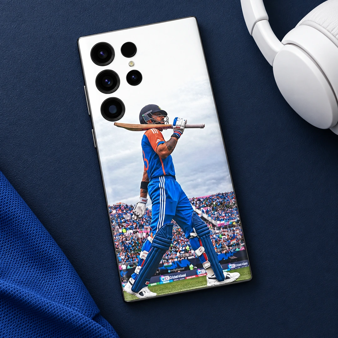 Virat Kohli Bat-on-Shoulder Mobile Skin – Navy desk flat lay Virat Kohli mobile skin with blue kit and bat across shoulders, navy desk flat lay