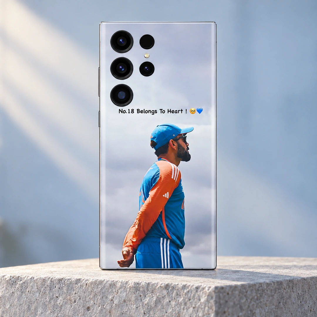 Virat Kohli No.18 Belongs To Heart Mobile Skin - light blue studio hero Virat Kohli mobile skin with No.18 Belongs To Heart message and blue-orange training portrait, light blue studio hero