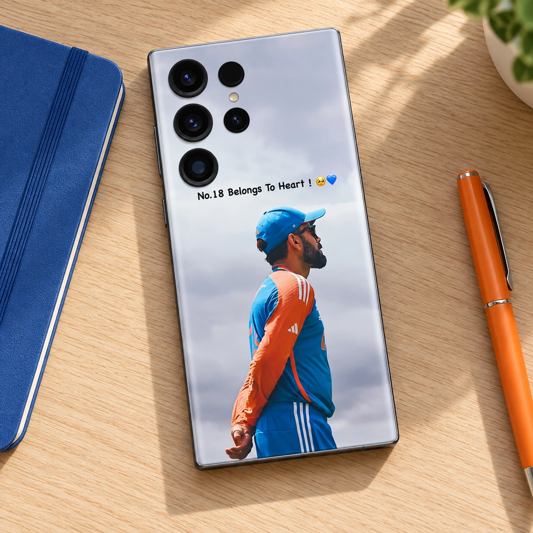 Virat Kohli No.18 Belongs To Heart Mobile Skin - oak desk flat lay Virat Kohli mobile skin with No.18 Belongs To Heart message and blue-orange training portrait, oak desk flat lay