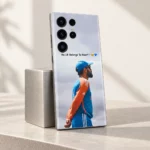 Virat Kohli mobile skin with No.18 Belongs To Heart message and blue-orange training portrait, silver display stand