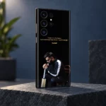 Black Virat Kohli mobile skin with gold 1% chance quote and seated portrait, slate studio angle