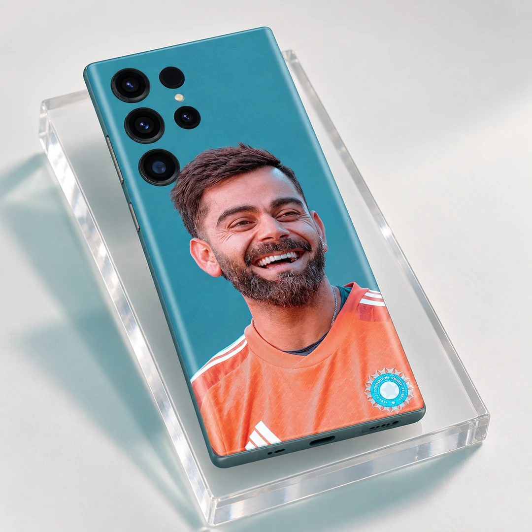 Virat Kohli Smiling Portrait Mobile Skin - Angled Acrylic Studio View Virat Kohli smiling in an orange training shirt on a teal mobile skin, angled acrylic studio view