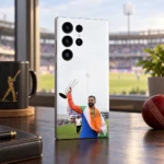 Virat Kohli raising a silver trophy while draped in the Indian tricolour on a mobile skin, stadium lounge angle
