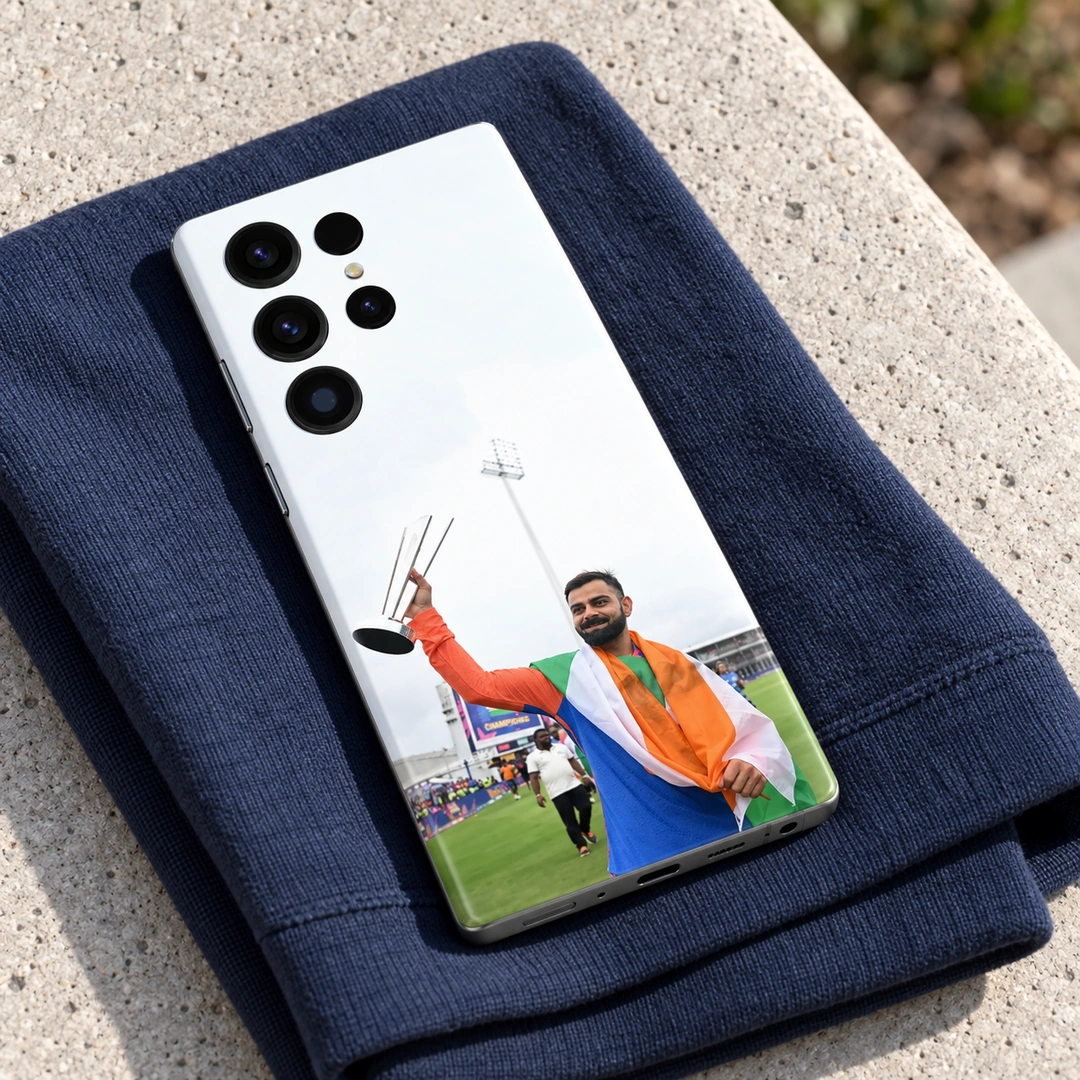 Virat Kohli Tricolour Trophy Mobile Skin - Navy fabric lifestyle Virat Kohli raising a silver trophy while draped in the Indian tricolour on a mobile skin, navy fabric lifestyle