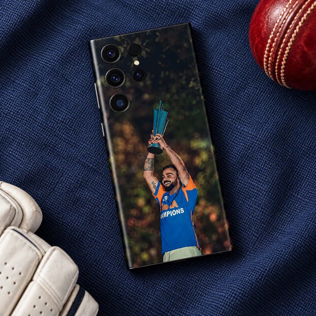 Virat Kohli Trophy Celebration Mobile Skin – Cricket Kit Flat Lay Virat Kohli trophy celebration photo mobile skin with blue and orange shirt, cricket kit flat lay