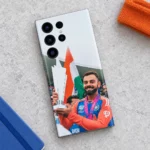 Virat Kohli trophy photo mobile skin with Indian tricolour, tricolour accessories flat lay