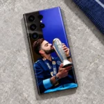 Virat Kohli kissing a silver trophy photo mobile skin, grey limestone flat lay