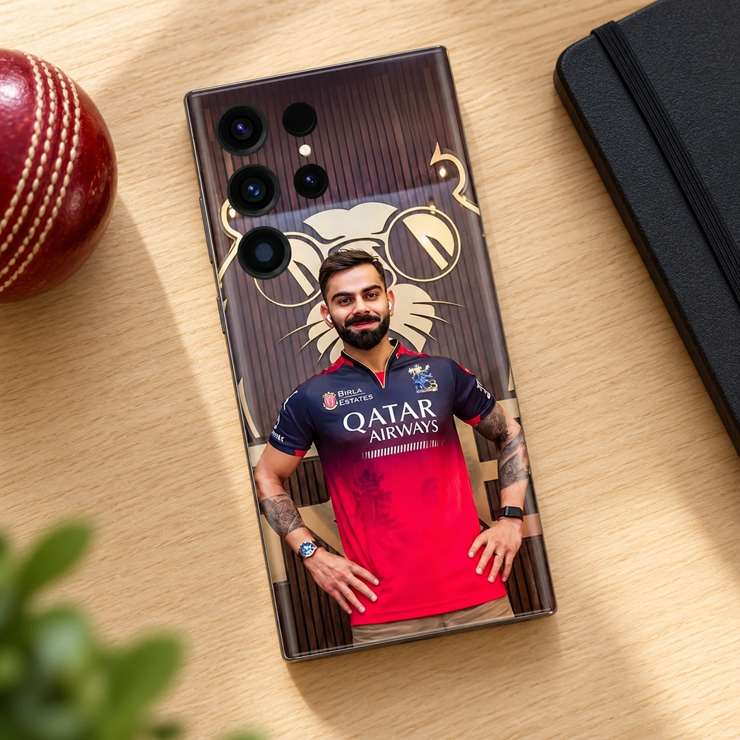 Virat Kohli Red Jersey Portrait Mobile Skin – Oak desk flat lay Virat Kohli mobile skin with red jersey portrait and gold lion backdrop, oak desk flat lay