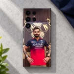 Virat Kohli mobile skin with red jersey portrait and gold lion backdrop, light concrete flat lay