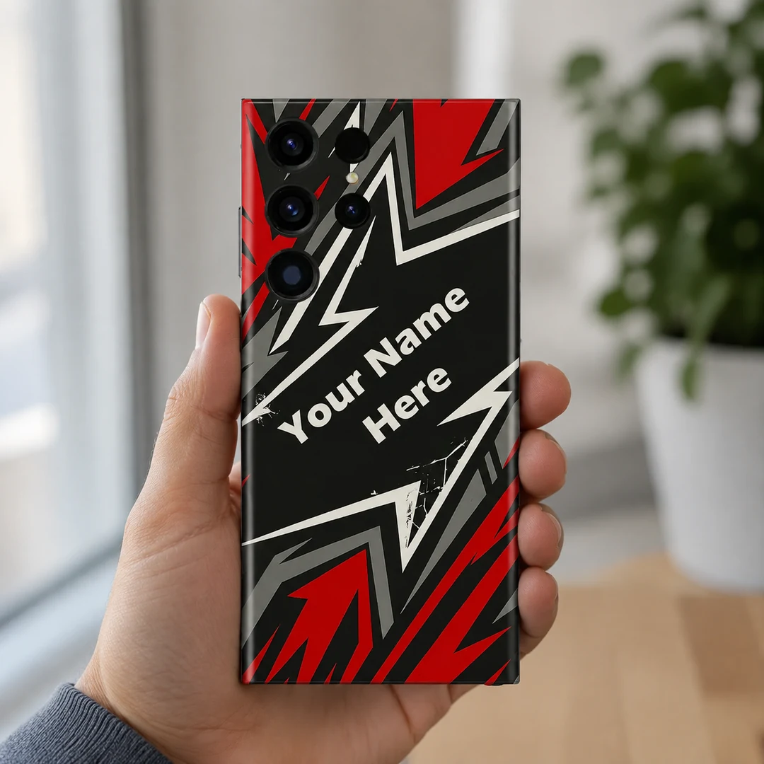 Custom Name Gaming Mobile Skin - in hand Custom Name Gaming Mobile Skin — in hand showing red, black, grey and white angular gaming artwork with diagonal sample name