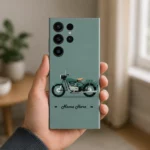 Classic Bullet Bike Customized Name Mobile Skin — in hand showing sage green background with a vintage motorcycle and cursive personalised name