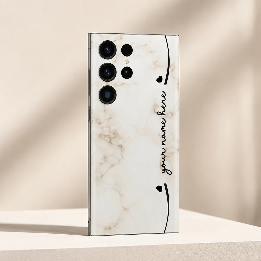 Elegant Marble Customized Name Mobile Skin - angled view Elegant Marble Customized Name Mobile Skin — angled view showing cream marble with black hearts and custom cursive name