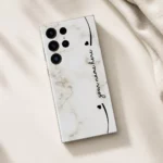 Elegant Marble Customized Name Mobile Skin — flat lay showing cream marble with black hearts and custom cursive name
