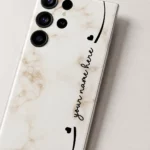 Elegant Marble Customized Name Mobile Skin — name detail showing cream marble with black hearts and custom cursive name