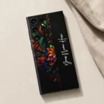 Royal Floral Glow Customized Name Mobile Skin — flat lay showing colourful floral scrollwork on black with vertical white cursive sample name