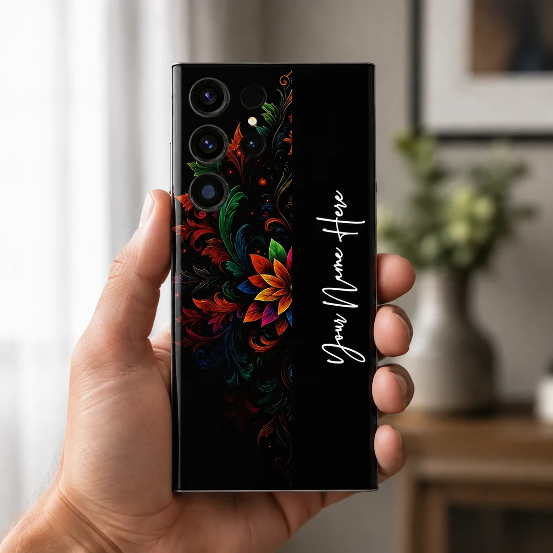 Royal Floral Glow Customized Name Mobile Skin - in hand Royal Floral Glow Customized Name Mobile Skin — in hand showing colourful floral scrollwork on black with vertical white cursive sample name