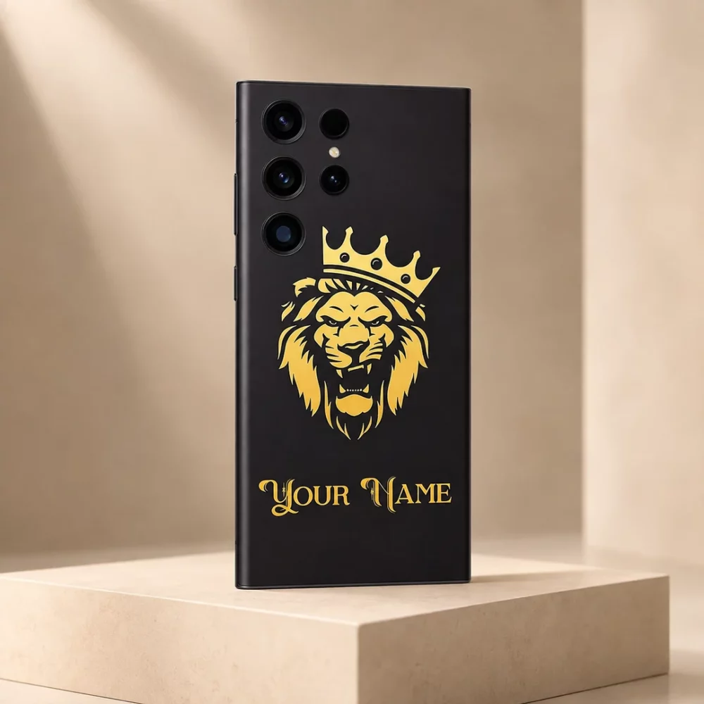 Royal Lion Crown Customized Name Mobile Skin — angled view showing a gold crowned lion on charcoal with ornate gold sample name lettering