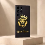 Royal Lion Crown Customized Name Mobile Skin — angled view showing a gold crowned lion on charcoal with ornate gold sample name lettering