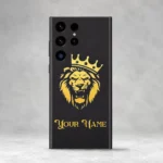 Royal Lion Crown Customized Name Mobile Skin — rear view showing a gold crowned lion on charcoal with ornate gold sample name lettering