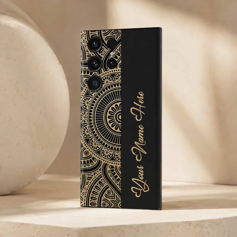 Royal Mandala Customized Name Mobile Skin — angled view showing the black and gold mandala design with gold cursive sample name