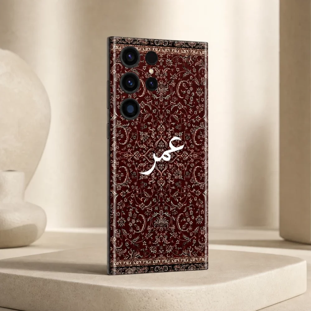 Damask Dunes Custom Name Mobile Skin — angled view showing burgundy damask floral artwork and white personalised calligraphy