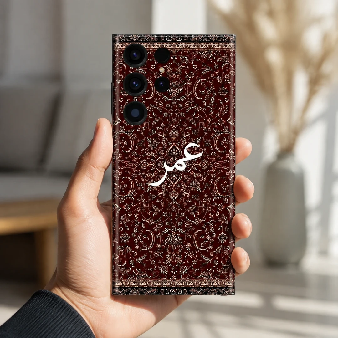 Damask Dunes Custom Name Mobile Skin - in hand Damask Dunes Custom Name Mobile Skin — in hand showing burgundy damask floral artwork and white personalised calligraphy