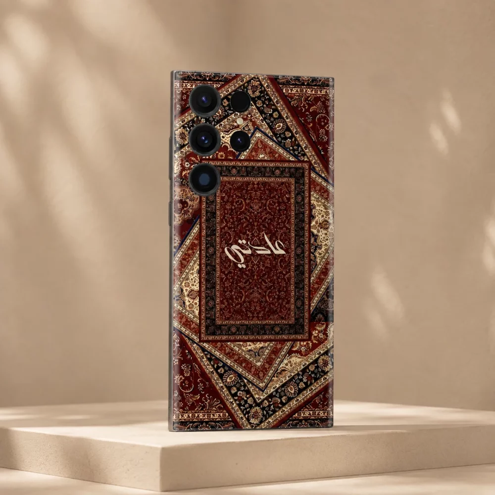 Sultan’s Grace Custom Name Mobile Skin — angled view showing burgundy, cream and black Persian rug motifs with central cream calligraphy
