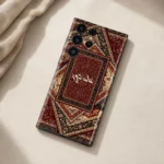 Sultan’s Grace Custom Name Mobile Skin — flat lay showing burgundy, cream and black Persian rug motifs with central cream calligraphy