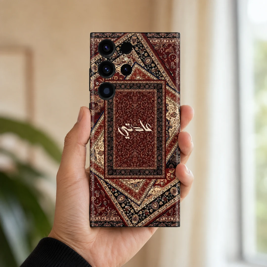 Sultan’s Grace Custom Name Mobile Skin - in hand Sultan’s Grace Custom Name Mobile Skin — in hand showing burgundy, cream and black Persian rug motifs with central cream calligraphy