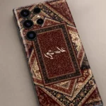 Sultan’s Grace Custom Name Mobile Skin — name detail showing burgundy, cream and black Persian rug motifs with central cream calligraphy