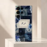 Velvet Persia Custom Name Mobile Skin — angled view showing navy Persian patterns, blue flowers and a cream custom name panel